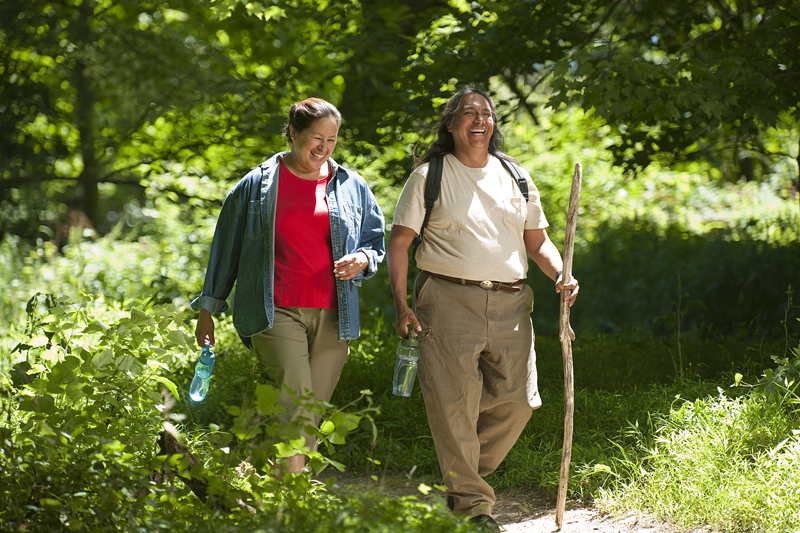 Two people walking outdoors. 